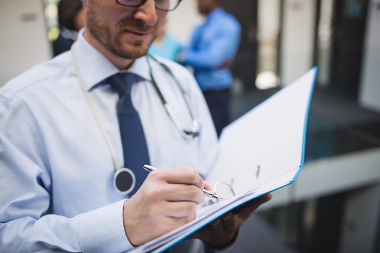 doctor-writing-medical-report
